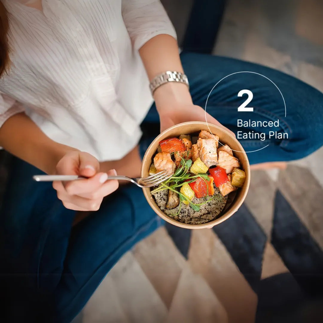 an image of a lady with a fork taking food from a bowl of salmon and rice